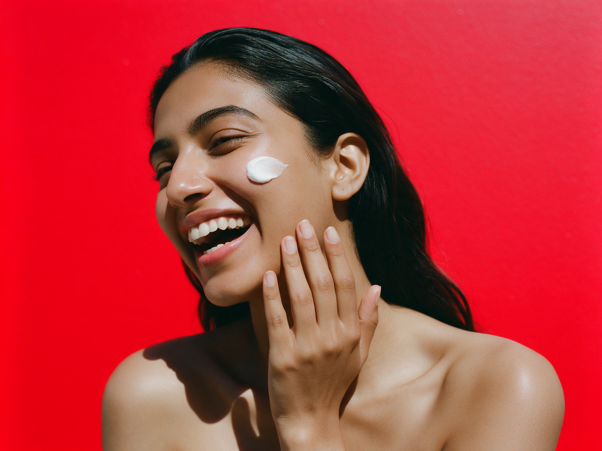 Laughing woman with a dab of whipped cream on her cheek